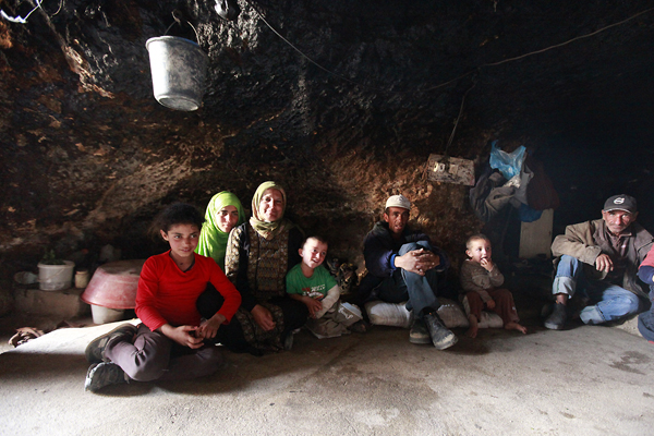 Family of Fadel Hamamdi gathered in their home. The caves are usually divided into three areas: a living area, a storage and cooking area, and one for livestock in winter.