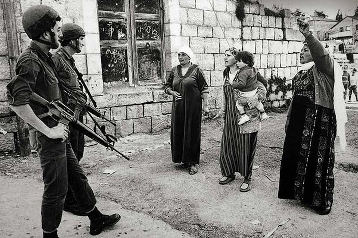 Women seen confronting Israeli troops in Gaza during the first intifada. After this photo was taken the women were assaulted and dispersed with truncheons and tear gas. [Robert Croma / maryscullyreports.com]