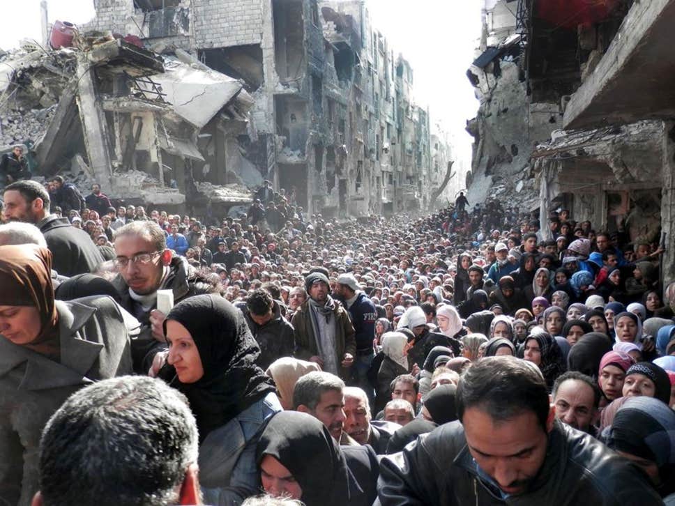 Palestinian refugees shown queuing for food supplies in the Yarmouk refugee camp in 2014 ( AP )